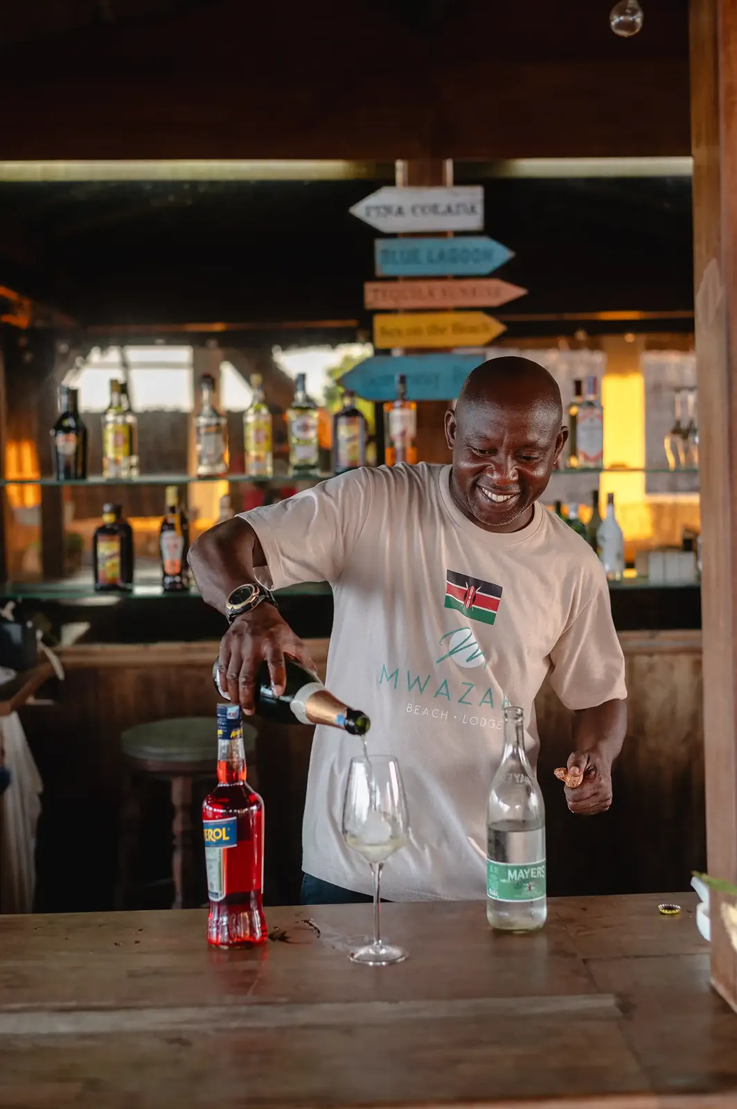 Barman pouring a cocktail at the beach bar