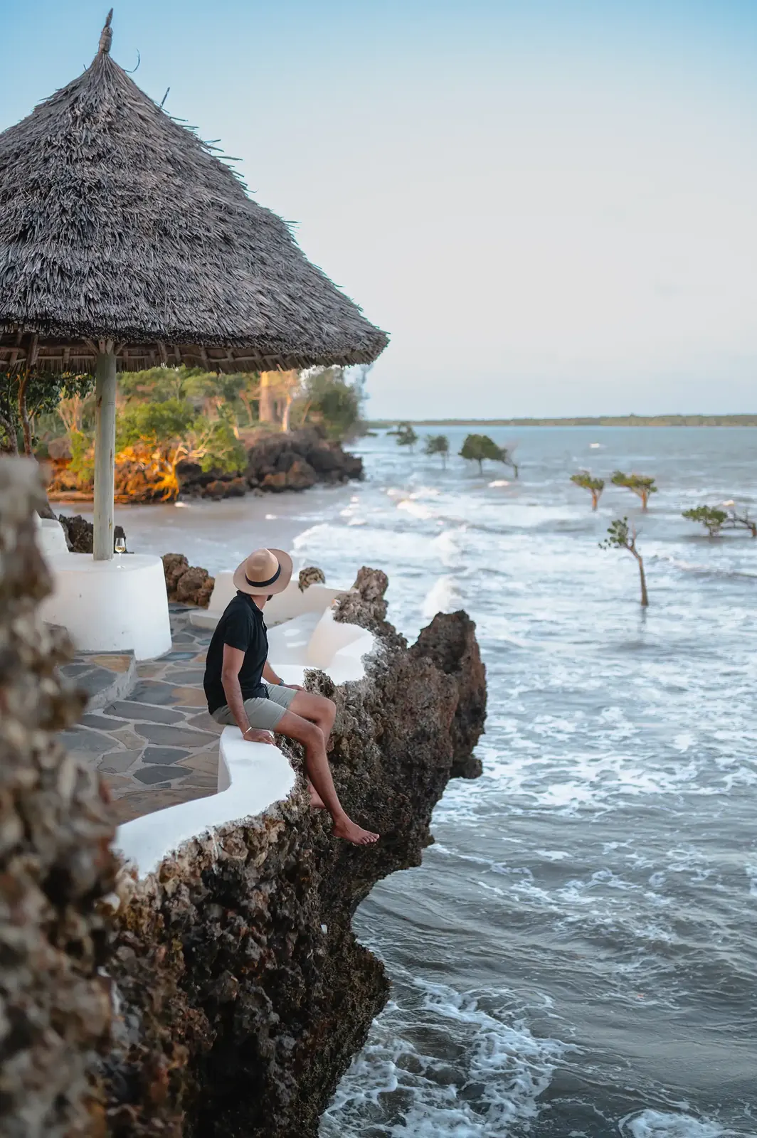 Guests exploring the coral rocks by the sea