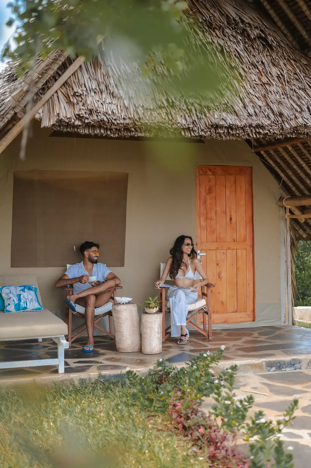 Guests enjoying drinks outside their bungalow