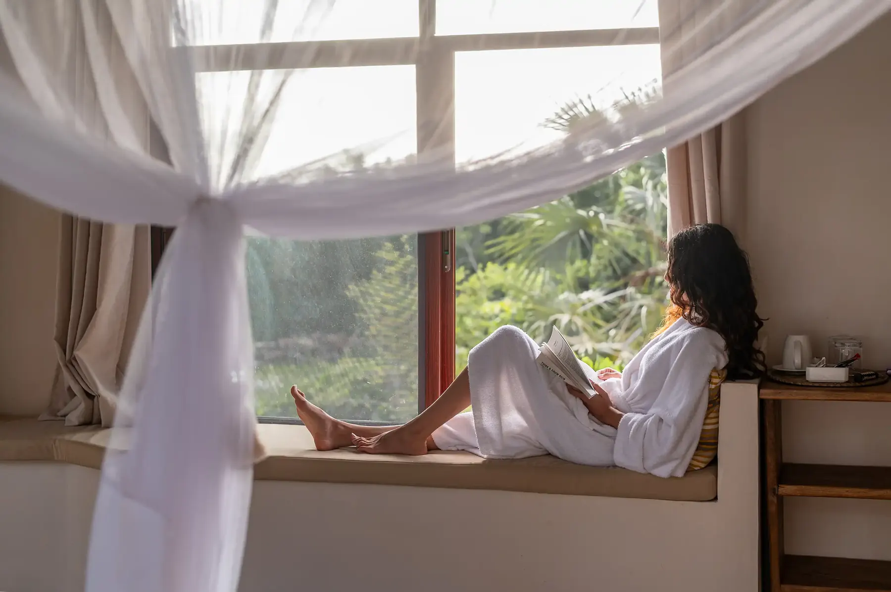 From bed to board — guest reading on the window seat