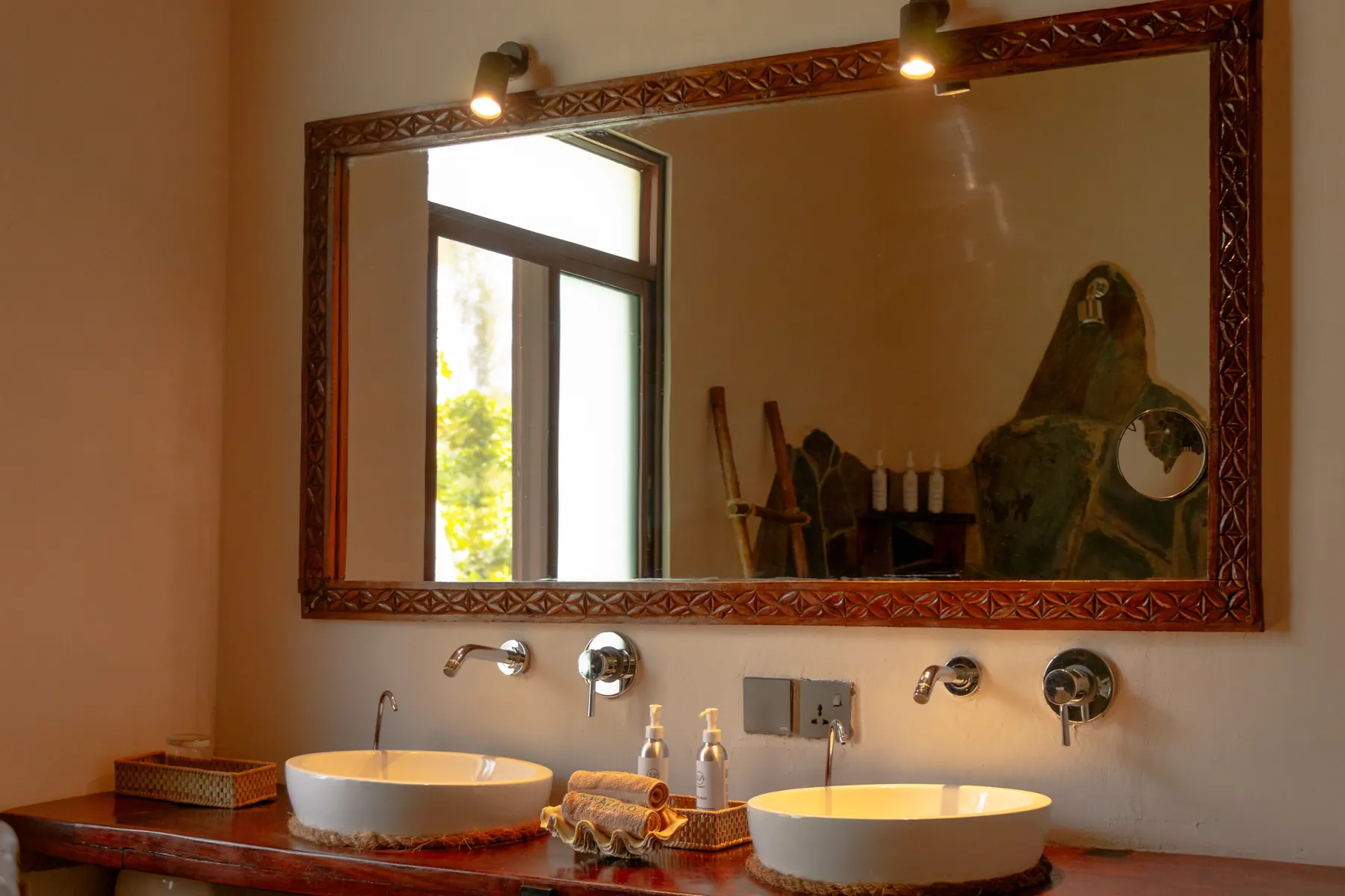 Twin washbasins in a stone-clad bathroom