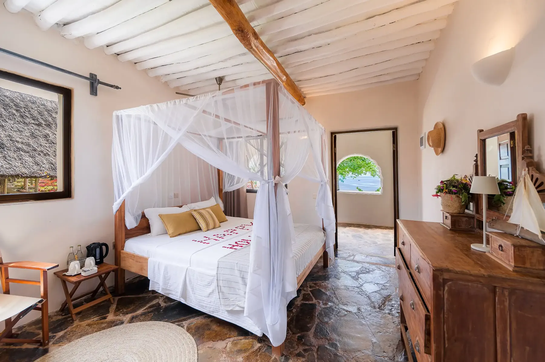 Coral house room with mosquito-net bed and sea breeze